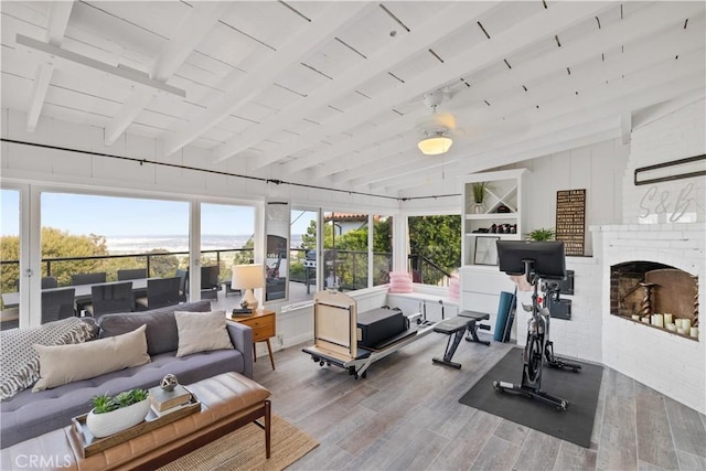 interior space with lofted ceiling with beams and wood finished floors