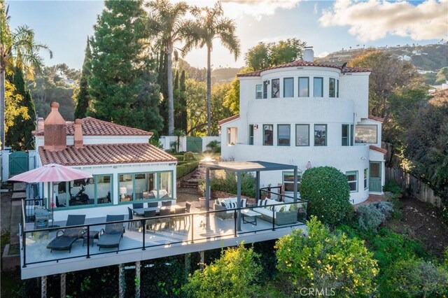 back of property with a wooden deck