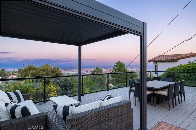 deck at dusk with an outdoor hangout area and outdoor dining space