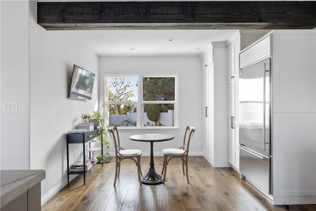 dining room featuring baseboards and light wood-type flooring