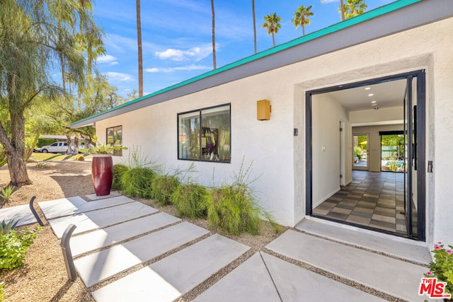 property entrance featuring a patio area