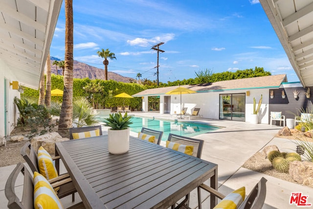 view of pool featuring a patio area and a mountain view