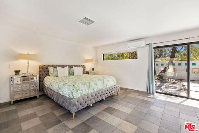 bedroom featuring an AC wall unit and access to exterior