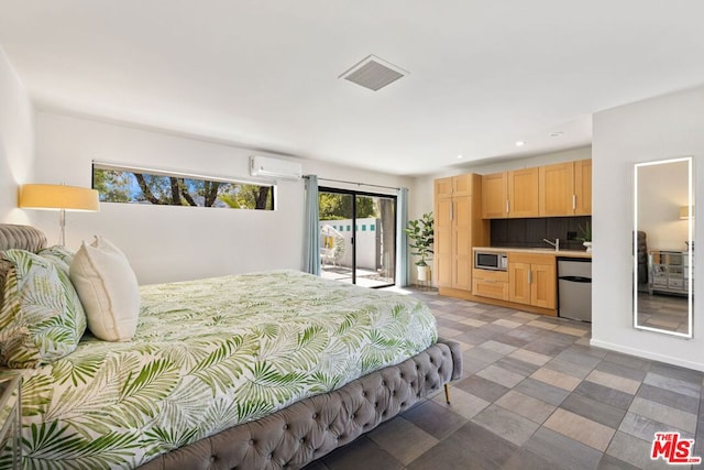 bedroom with an AC wall unit, sink, and access to outside