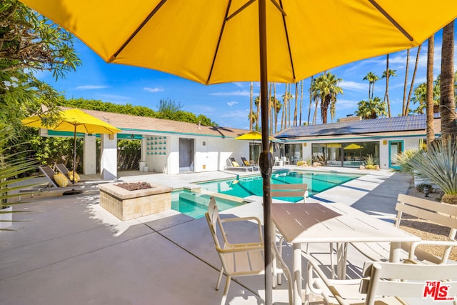 view of pool featuring a fire pit and a patio