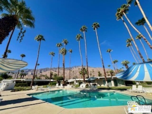 view of swimming pool with a mountain view