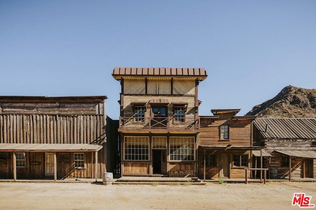 back of property with a balcony