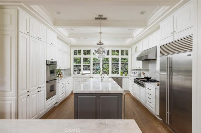 kitchen with ventilation hood, white cabinets, hanging light fixtures, and appliances with stainless steel finishes