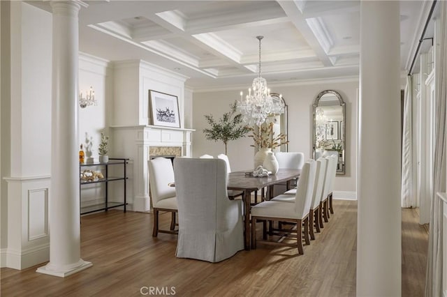 dining space with coffered ceiling, hardwood / wood-style flooring, ornate columns, ornamental molding, and beam ceiling