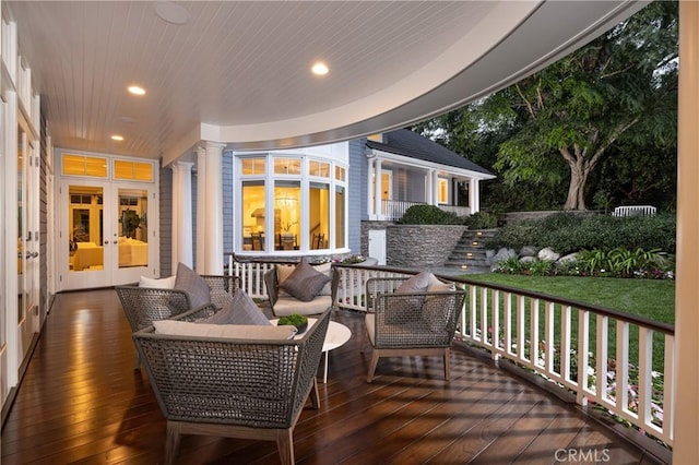 deck with outdoor lounge area, a yard, and french doors