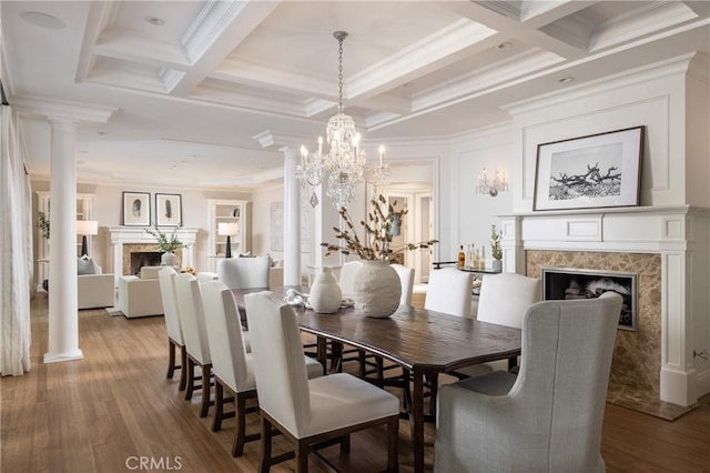 dining space with hardwood / wood-style floors, beam ceiling, crown molding, and coffered ceiling