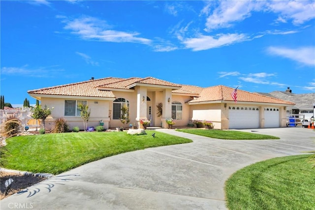 mediterranean / spanish house featuring a garage and a front lawn