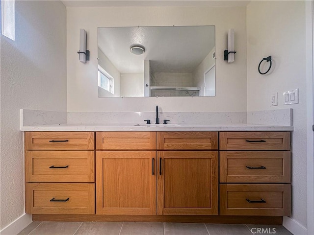 bathroom with tile patterned floors and vanity