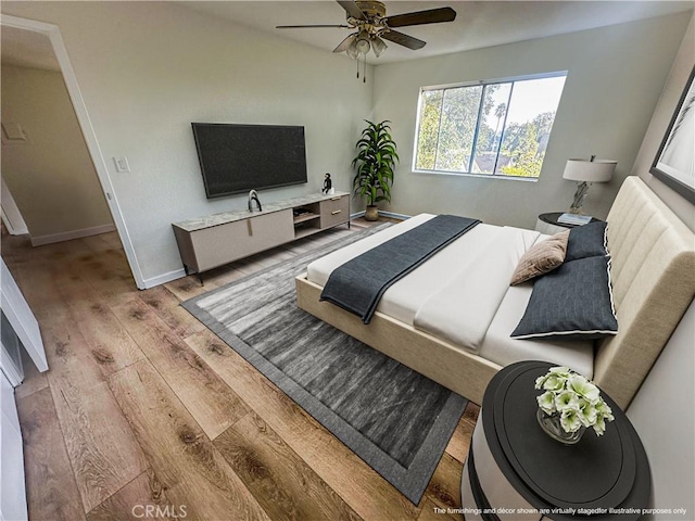 bedroom with wood-type flooring and ceiling fan