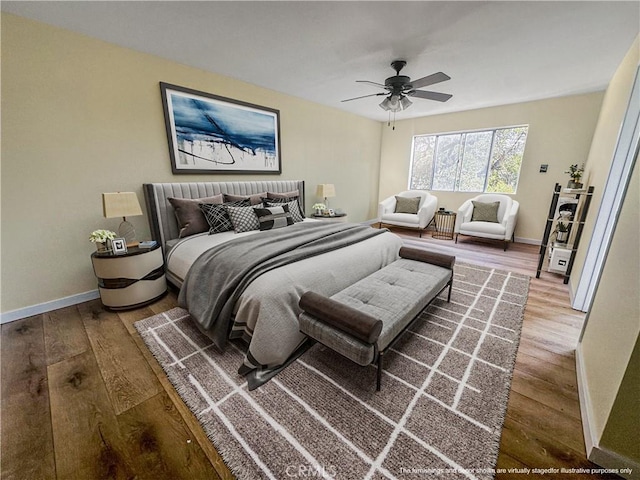 bedroom with hardwood / wood-style floors and ceiling fan