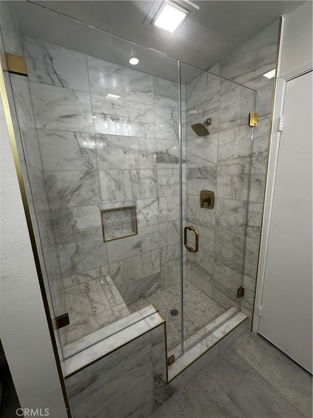 bathroom with a shower with shower door