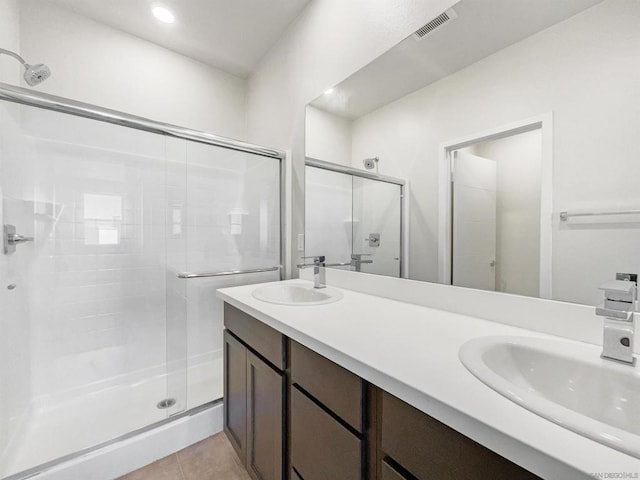 bathroom featuring vanity, tile patterned floors, and an enclosed shower