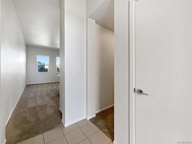 hallway with light colored carpet