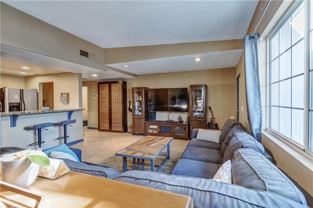 living room with light tile patterned flooring and lofted ceiling