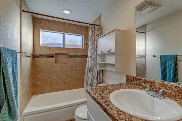 full bathroom with shower / tub combo, vanity, and toilet