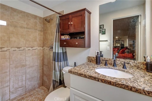 bathroom featuring walk in shower, vanity, and toilet