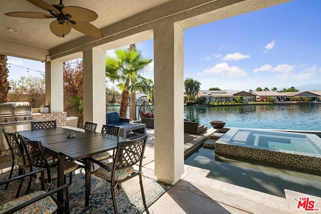 view of patio with ceiling fan and a water view