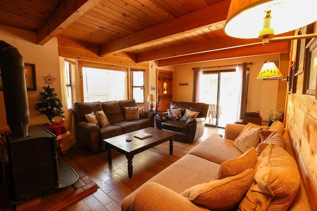 living room with hardwood / wood-style flooring, beam ceiling, wooden ceiling, and a wood stove