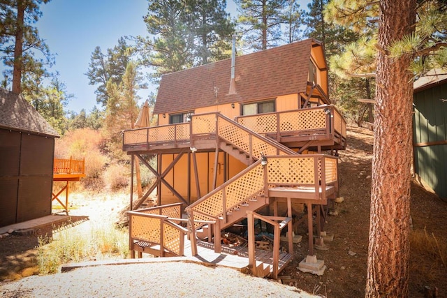 rear view of property featuring a deck