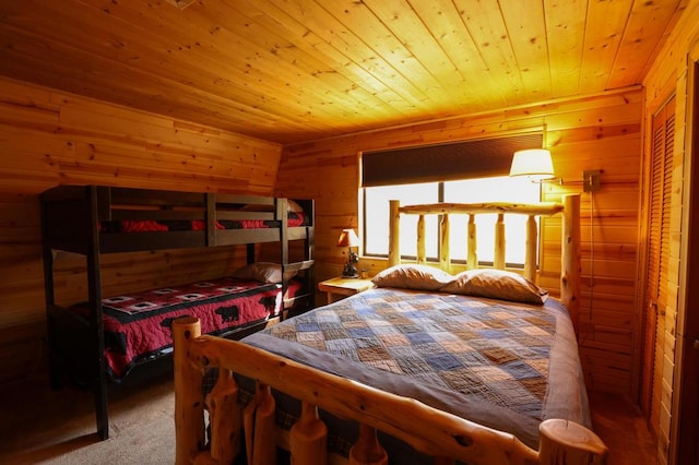 carpeted bedroom with wooden ceiling and wooden walls