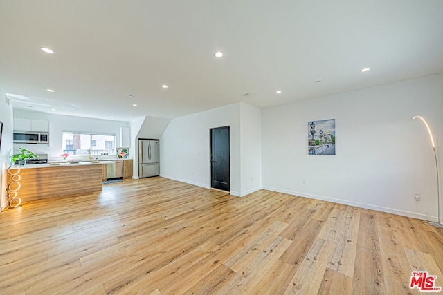 unfurnished living room featuring light wood-type flooring