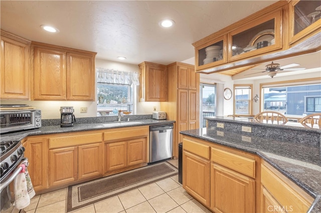 kitchen with light tile patterned floors, a healthy amount of sunlight, sink, and stainless steel appliances