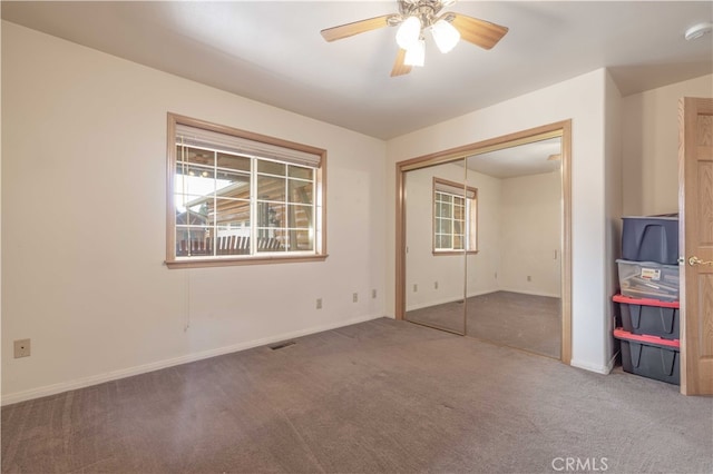 unfurnished bedroom with carpet floors, a closet, and ceiling fan