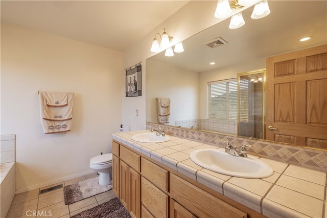 bathroom featuring vanity, tile patterned flooring, toilet, and decorative backsplash