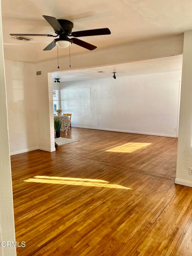 spare room with ceiling fan and hardwood / wood-style flooring