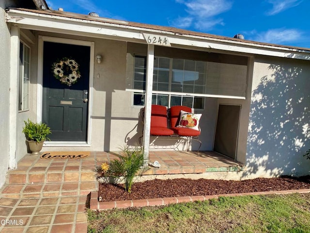 property entrance featuring a patio area