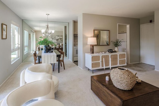 carpeted living room with a chandelier