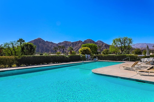 view of swimming pool featuring a patio area and a mountain view