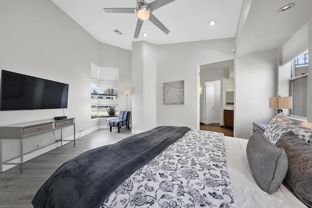 bedroom with a high ceiling, dark hardwood / wood-style flooring, and ceiling fan