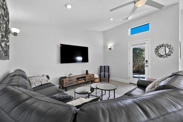 living room with light wood-type flooring and ceiling fan