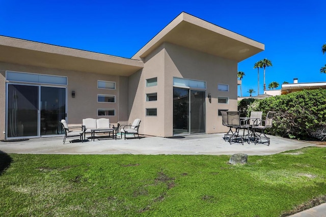 rear view of house with an outdoor living space, a patio, and a lawn