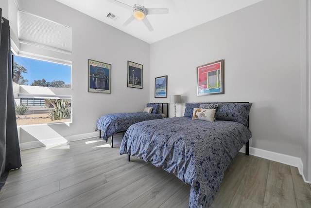 bedroom with ceiling fan and hardwood / wood-style flooring