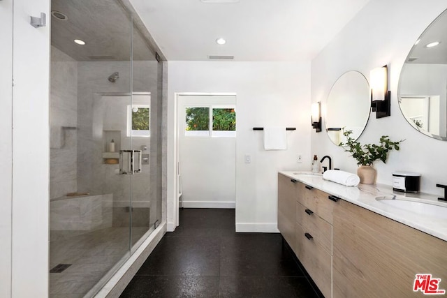 bathroom featuring vanity and an enclosed shower