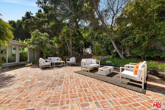 view of patio featuring an outdoor living space with a fire pit