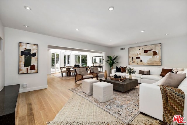 living room with light hardwood / wood-style flooring