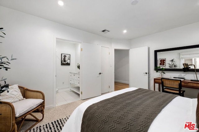 carpeted bedroom with ensuite bath