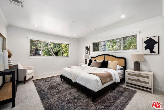 bedroom with crown molding and light colored carpet