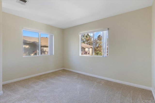 spare room with a healthy amount of sunlight and carpet floors