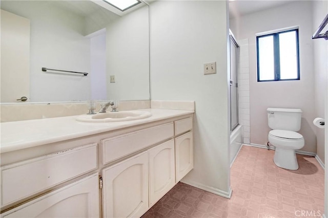 full bathroom with vanity, toilet, and combined bath / shower with glass door