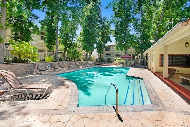 view of swimming pool with a patio area