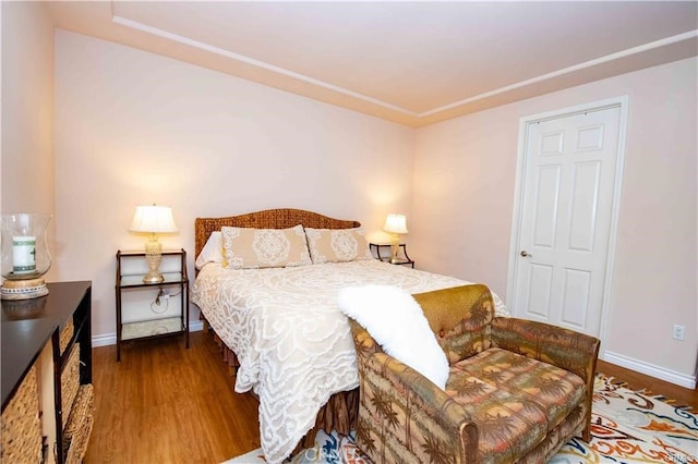 bedroom with dark wood-type flooring